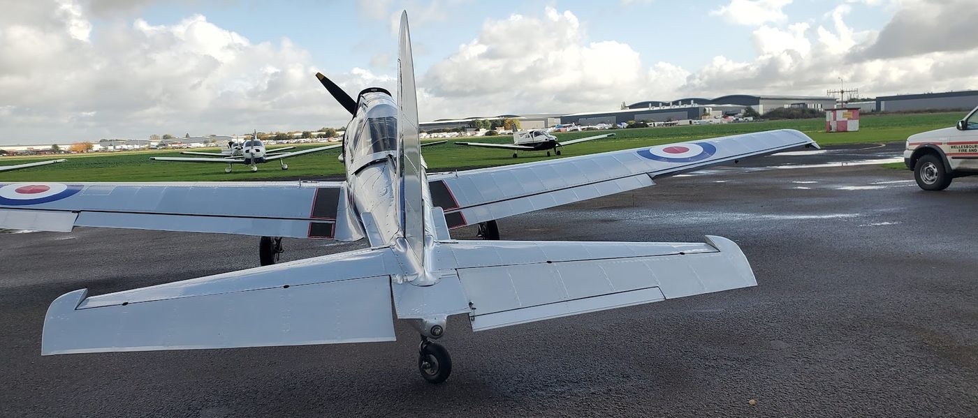 Silver military trainer on the apron at Wellesbourne Mountford Airfield